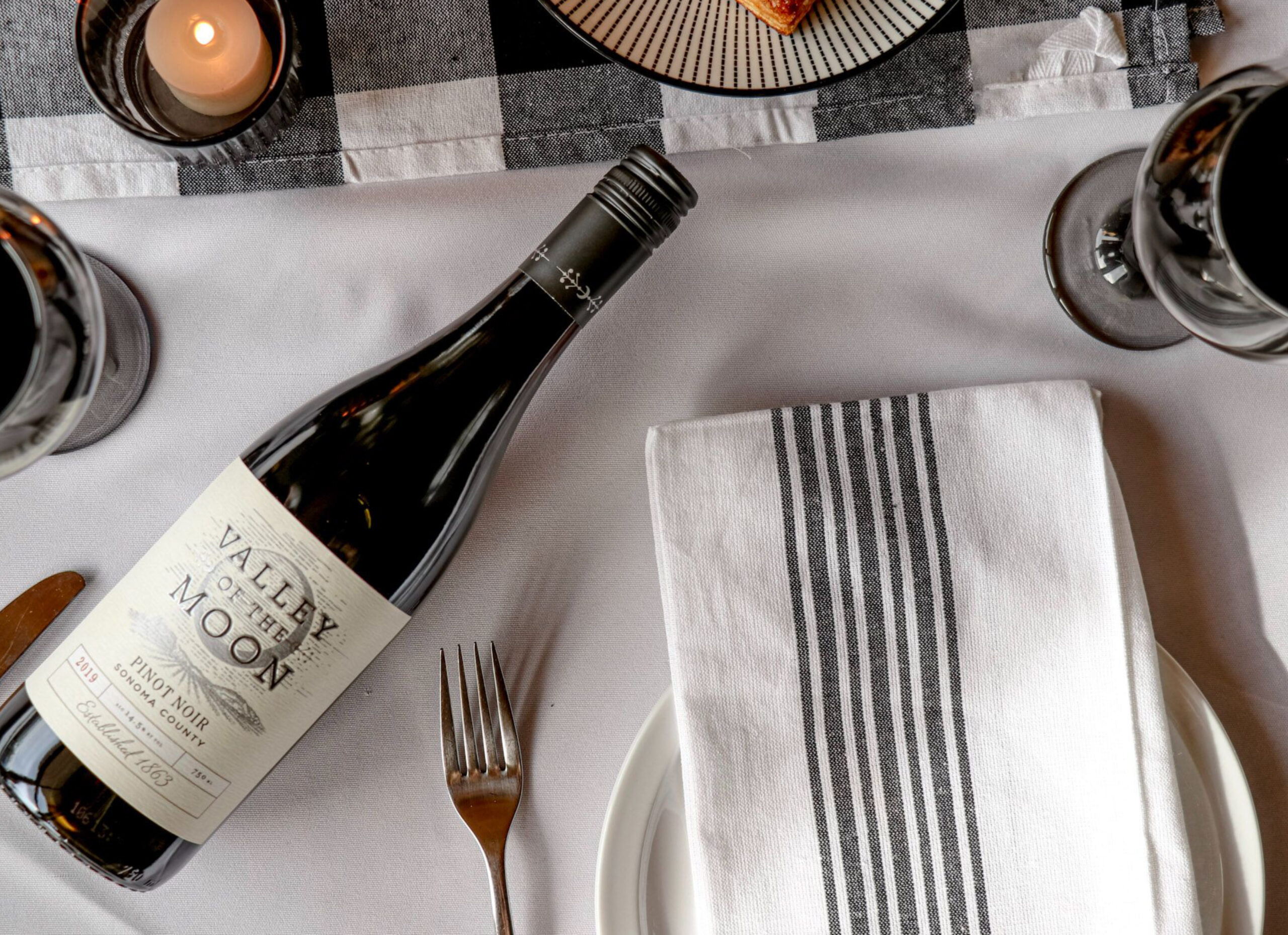 Valley of the Moon Pinot Noir bottle on white table cloth table setting